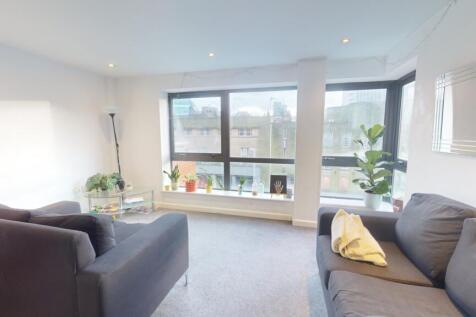 Bright and inviting living room featuring large...
