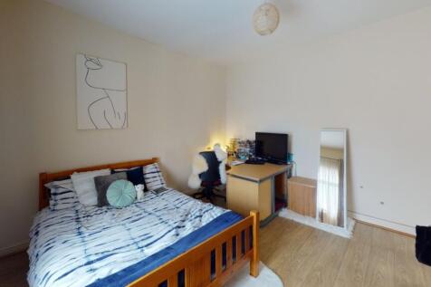 A bright and tidy double bedroom featuring a wo...