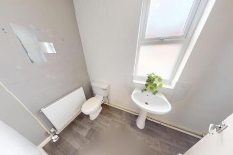 Bright and clean single toilet room featuring a...