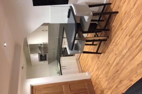 A modern kitchenette with a stylish dining area...
