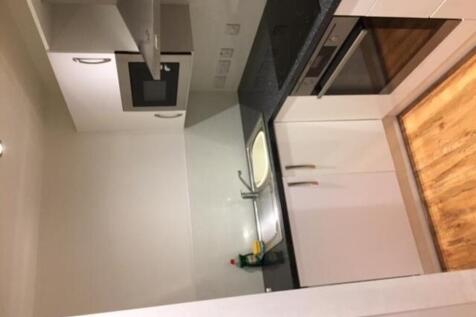 A modern kitchenette equipped with essential ap...
