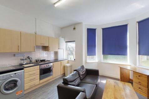 A bright and tidy kitchen featuring modern wood...