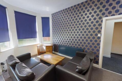 A cozy communal lounge featuring a set of dark ...