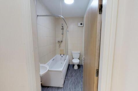 A neat and functional bathroom featuring a bath...