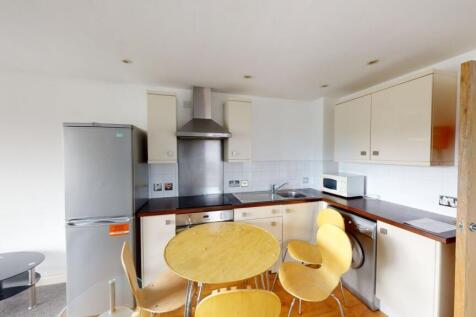 Bright and modern kitchen featuring white cabin...