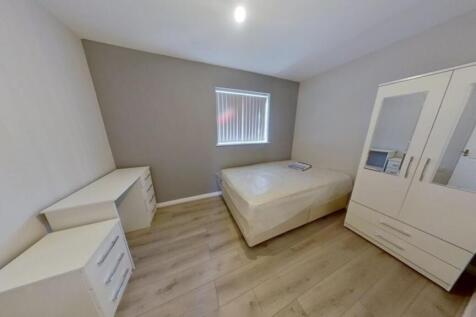 A clean and modern single toilet room with neut...