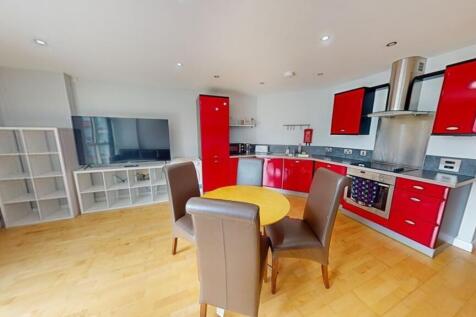 Bright and modern kitchen with vibrant red cabi...