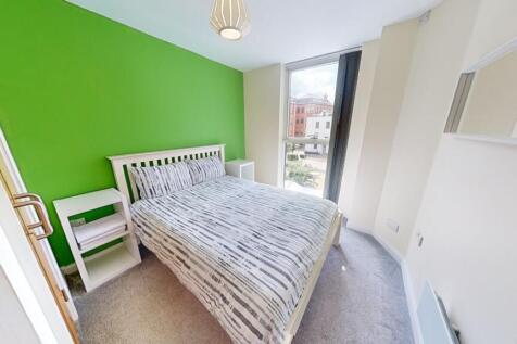 Bright single bedroom with a fresh green accent...