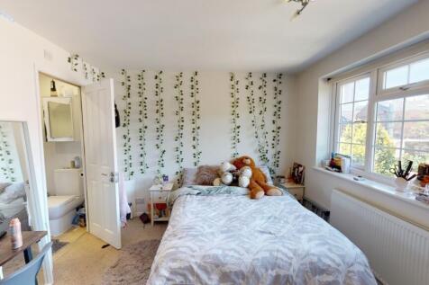 A bright and cozy double bedroom featuring a la...