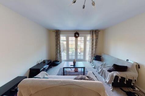 A cozy living room with a large window allowing...