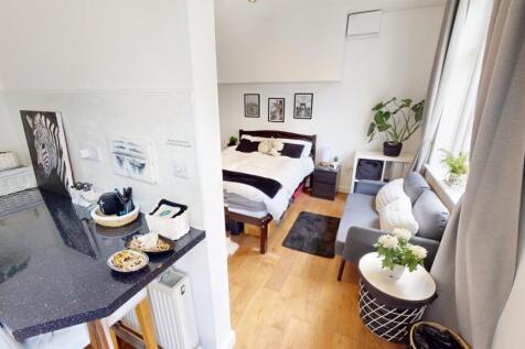 A bright and stylish master bedroom featuring a...