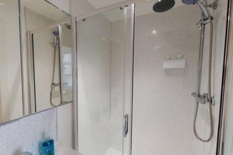 Bright and modern bathroom suite featuring a wa...