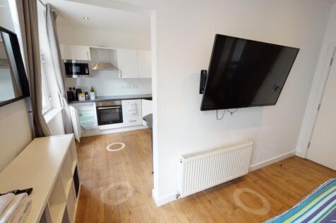 Bright and modern double bedroom featuring a wa...