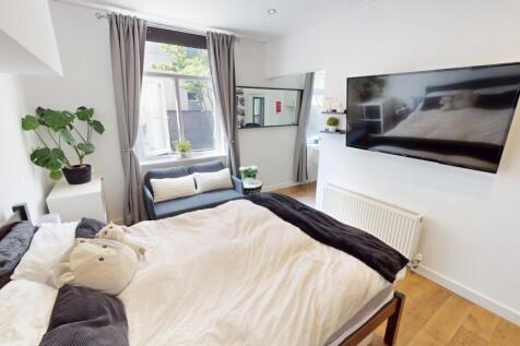 Bright and cozy double bedroom featuring a larg...