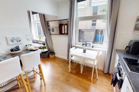 Bright and modern kitchen featuring two large w...