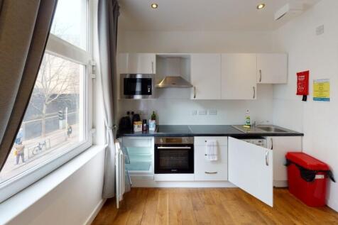 Bright and modern kitchen space featuring white...