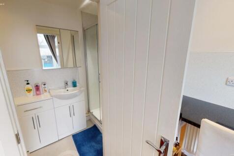 A clean and modern bathroom featuring a white v...