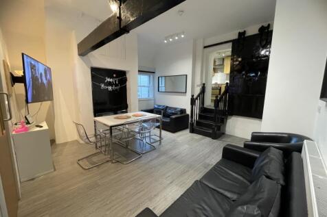 A contemporary living room featuring sleek blac...