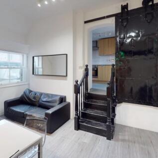 Bright and modern living room featuring a sleek...