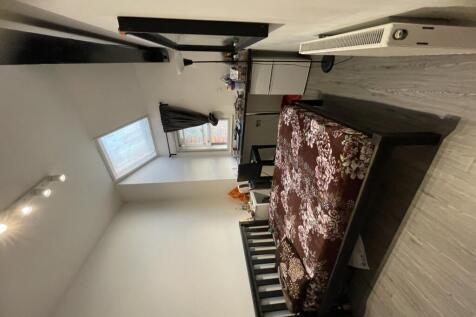 A neat and well-lit double bedroom featuring a ...