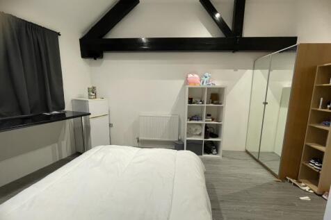 A clean and modern double bedroom featuring a c...