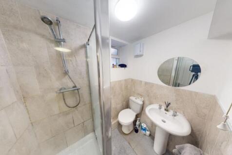 A clean and modern bathroom suite featuring a s...