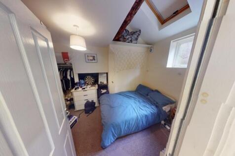 A cozy master bedroom featuring a double bed wi...