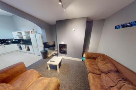 A comfortable living room featuring cozy brown ...