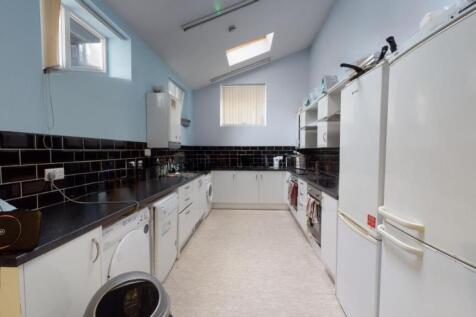 Bright and clean kitchen featuring modern black...
