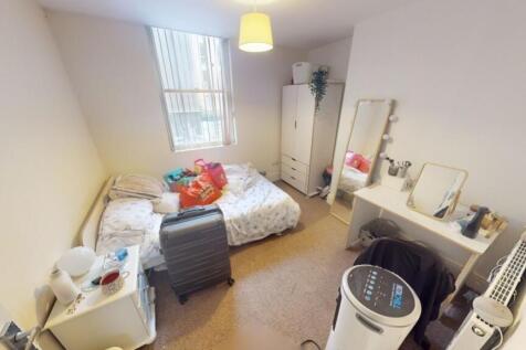 Bright double bedroom featuring a comfortable d...