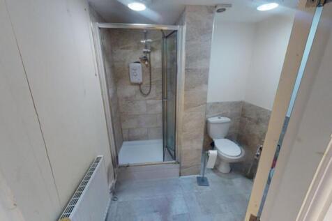 A clean and modern bathroom featuring a glass s...