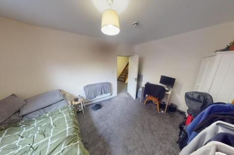 A cozy single bedroom featuring a comfortable b...