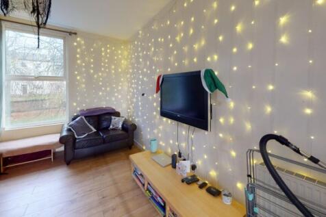 A cozy living room featuring a comfortable armc...