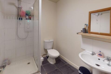 A clean and functional bathroom featuring a wal...