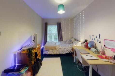 A cozy and well-organized single bedroom featur...