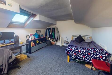 Bright and spacious attic bedroom featuring a c...