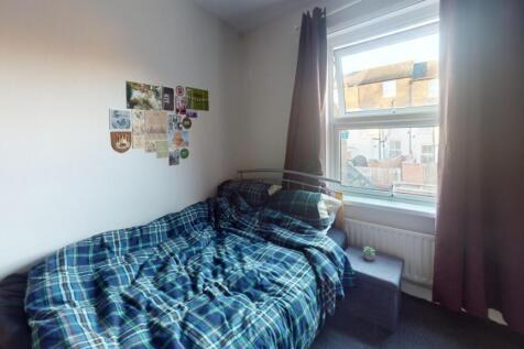 Cozy single bedroom featuring a comfortable bed...