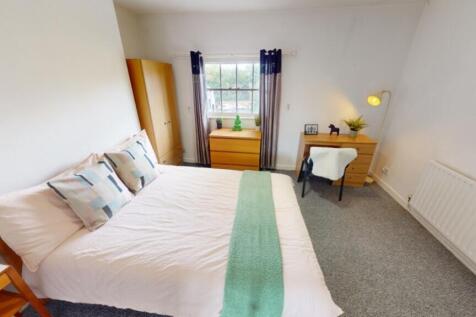 A bright and inviting double bedroom with moder...