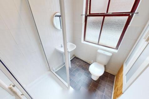 A bright and tidy bathroom featuring a modern s...