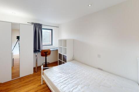 A bright and spacious double bedroom with moder...