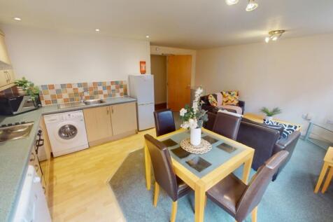 A bright and tidy open-plan living area featuri...