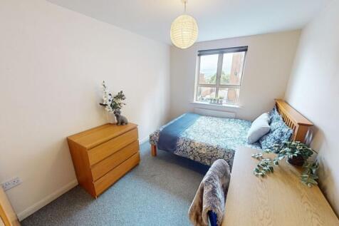 A bright and welcoming double bedroom featuring...