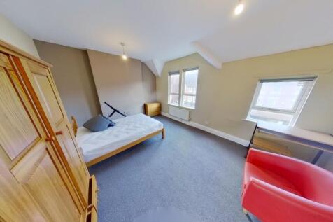 Bright and spacious bedroom featuring a comfort...