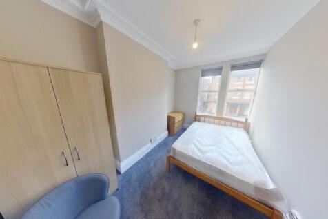 A neat and simple single bedroom featuring a la...