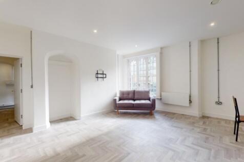 A spacious and bright modern living room with a...