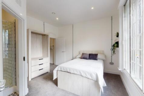 A bright and spacious double bedroom featuring ...