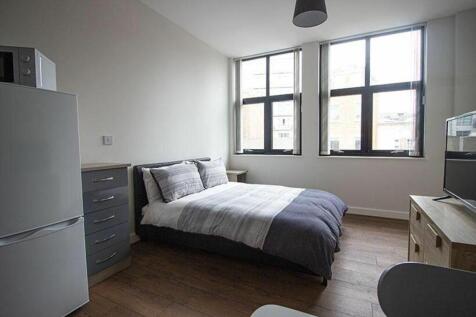 Spacious double bedroom featuring large windows...