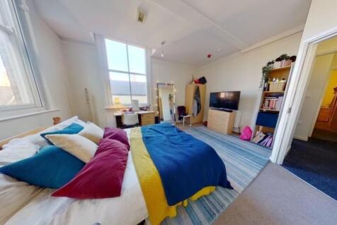 Bright and spacious master bedroom featuring a ...