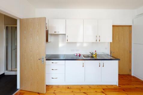Bright and clean kitchen with modern white cabi...