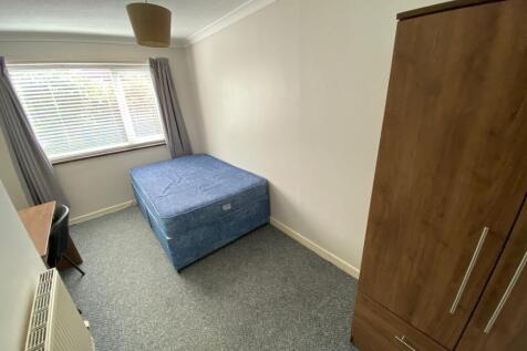 This inviting double bedroom features a comfort...